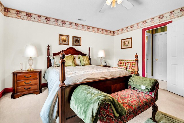 carpeted bedroom with baseboards, visible vents, and a ceiling fan