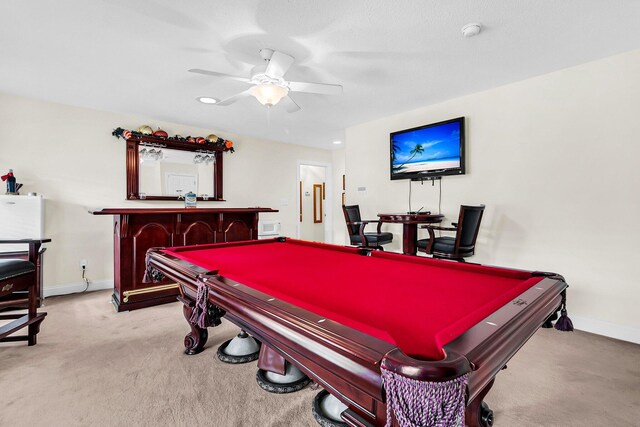 game room featuring baseboards, ceiling fan, a bar, light carpet, and billiards