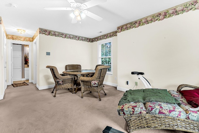 carpeted dining area featuring ceiling fan