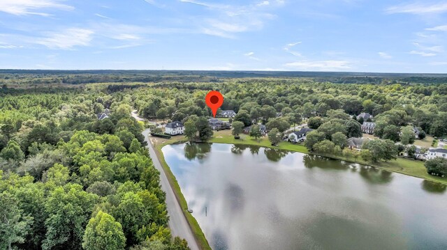 aerial view featuring a water view and a forest view