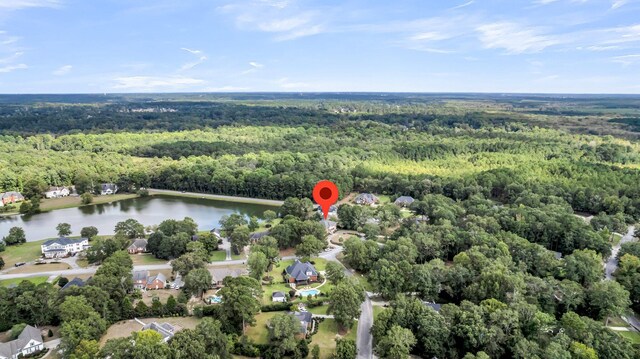 drone / aerial view with a water view and a wooded view