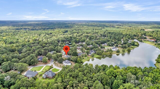 aerial view with a wooded view and a water view