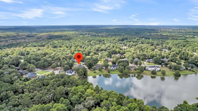 drone / aerial view featuring a water view and a forest view