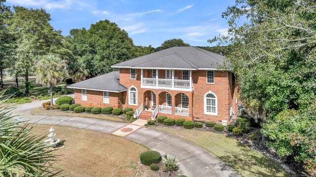 view of front of property with a balcony and a porch