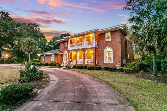 view of front of house with a porch and a lawn