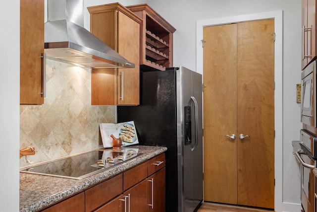 150 Bee St Unit 308, Charleston, SC 29401 - kitchen with wall chimney exhaust hood, stainless steel appliances, tasteful backsplash, and brown cabinets