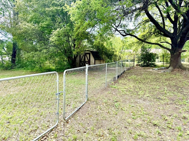 view of yard with fence and an outbuilding