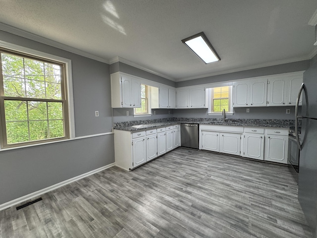 kitchen featuring stainless steel dishwasher, a sink, crown molding, white cabinets, and wood finished floors