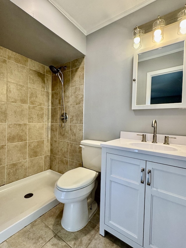 full bath featuring crown molding, tile patterned floors, vanity, toilet, and a tile shower