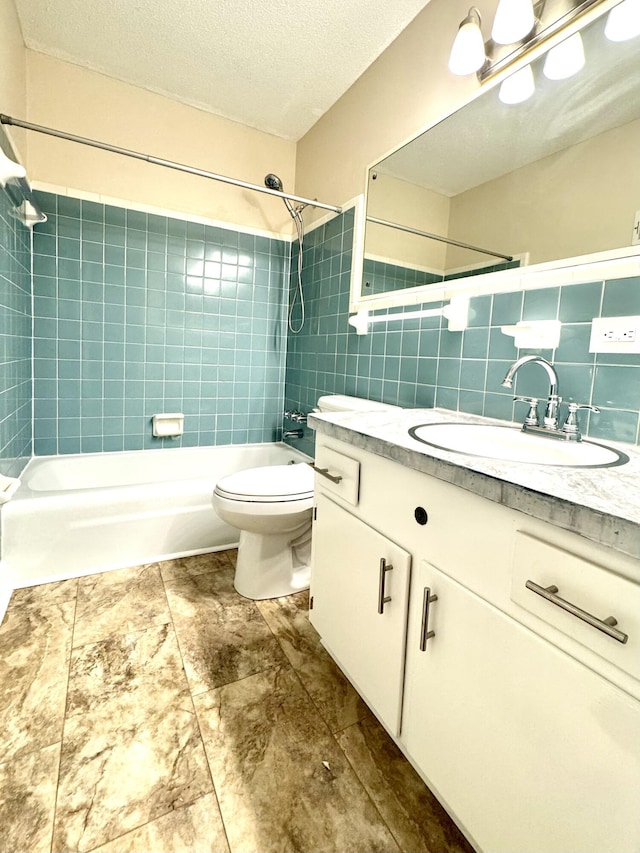 full bathroom with tasteful backsplash, vanity, a textured ceiling, tile walls, and tiled shower / bath