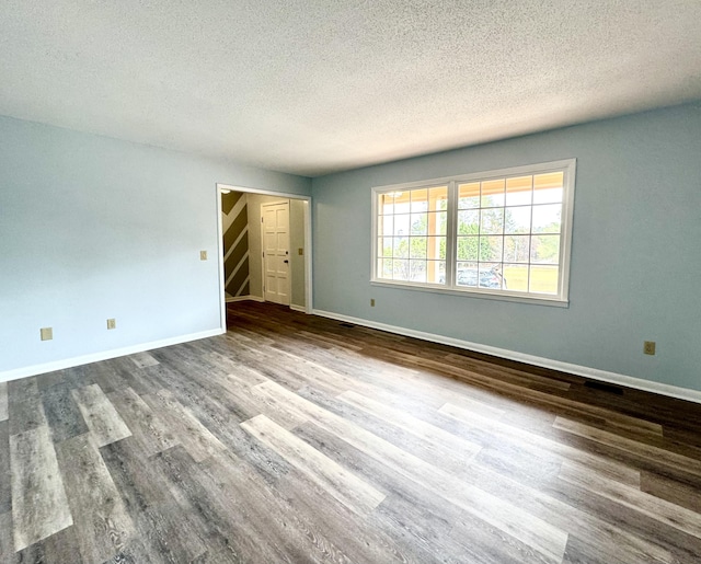 interior space with wood-type flooring and a textured ceiling