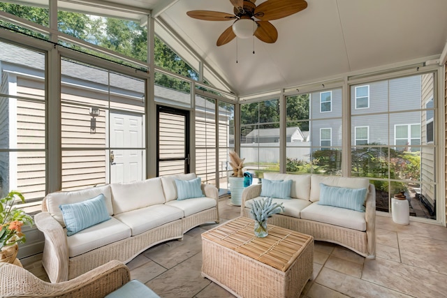 sunroom / solarium featuring a ceiling fan, vaulted ceiling, and a wealth of natural light