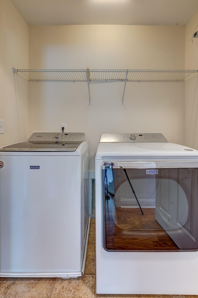 clothes washing area with laundry area and washer and dryer