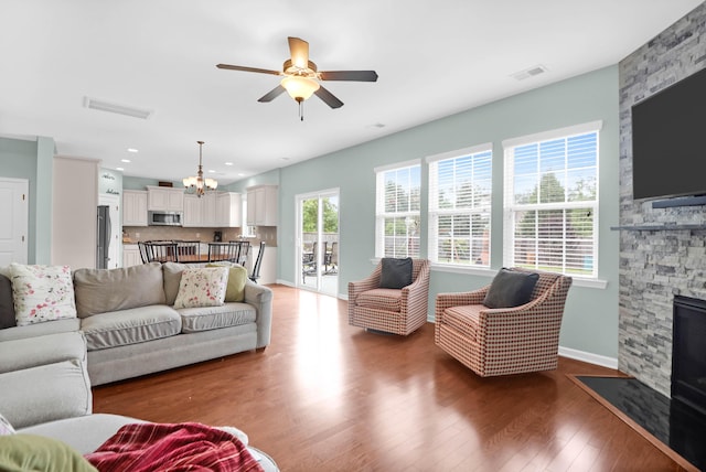 9785 Black Willow Ln, Ladson, SC 29456 - living area with a chandelier, a fireplace, ceiling fan, wood finished floors, and baseboards