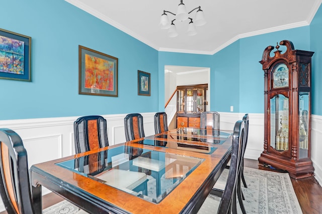 9785 Black Willow Ln, Ladson, SC 29456 - dining room with a chandelier, ornamental molding, wood finished floors, and a wainscoted wall