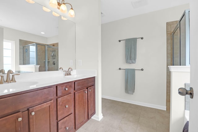 9785 Black Willow Ln, Ladson, SC 29456 - bathroom featuring a stall shower, double vanity, tile patterned flooring, and baseboards