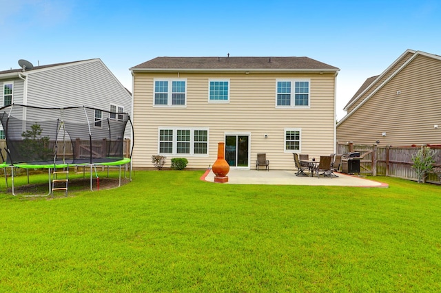 9785 Black Willow Ln, Ladson, SC 29456 - back of house featuring a trampoline and a patio