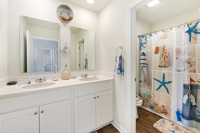 full bathroom featuring hardwood / wood-style flooring, vanity, toilet, and shower / bath combo