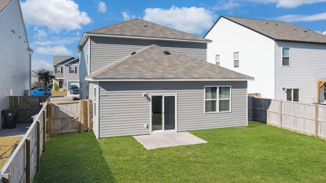 back of house with a patio and a lawn