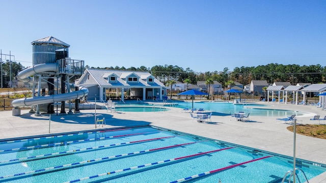 view of swimming pool featuring a patio and a water slide