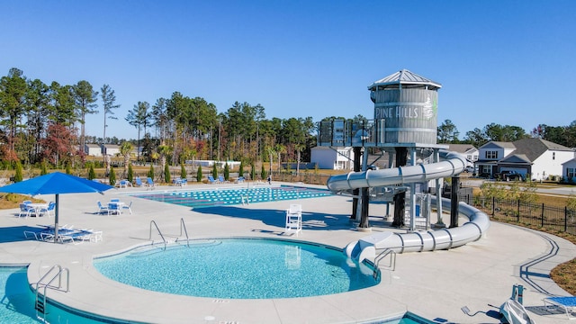 view of pool with a patio area and a water slide