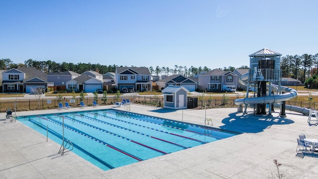 view of pool with a patio area and a water slide