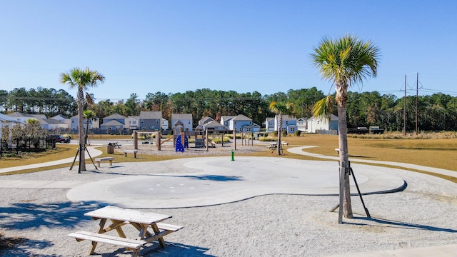 view of home's community with a playground and a lawn