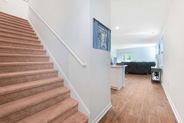 stairs with wood-type flooring