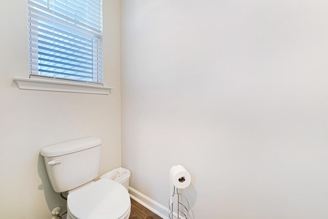 bathroom with hardwood / wood-style floors and toilet