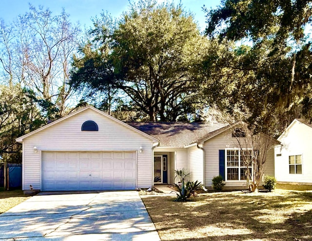 ranch-style home with a garage, concrete driveway, and a front lawn