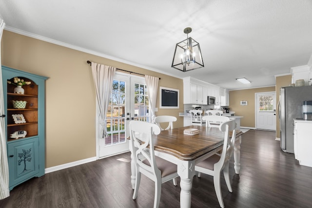 dining area featuring ornamental molding, dark hardwood / wood-style floors, and french doors