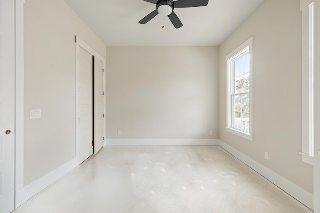 unfurnished room featuring ceiling fan and plenty of natural light