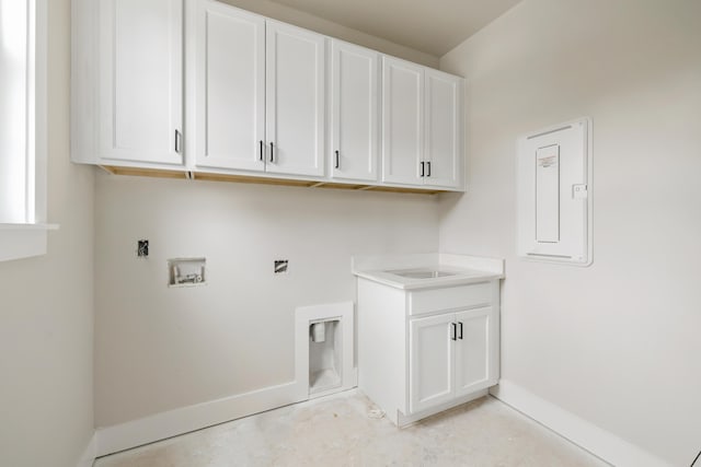 washroom featuring hookup for a washing machine and cabinets