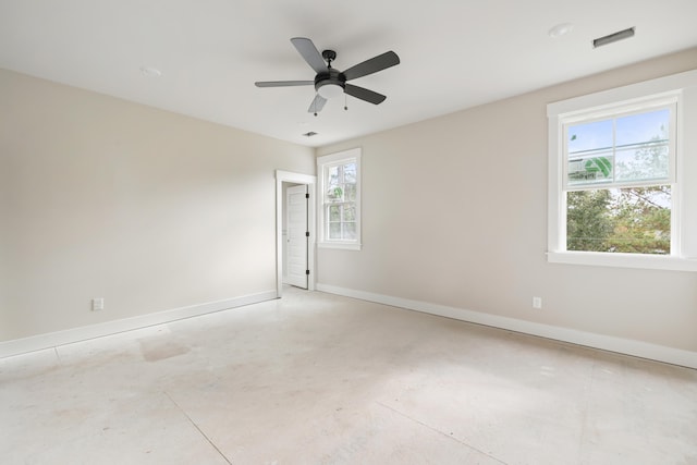 spare room featuring ceiling fan and a healthy amount of sunlight