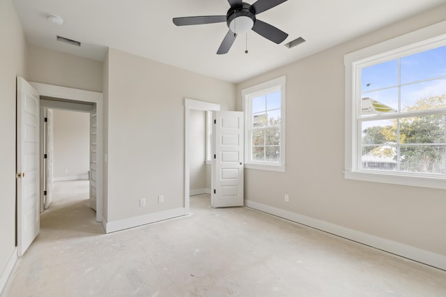 unfurnished bedroom with ceiling fan, a spacious closet, and a closet