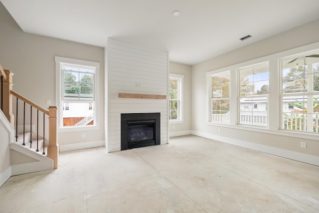 unfurnished living room featuring a large fireplace