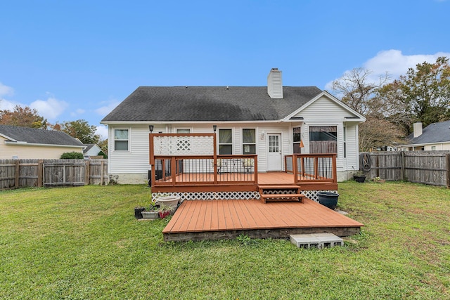 back of property featuring a chimney, a shingled roof, a lawn, a fenced backyard, and a wooden deck