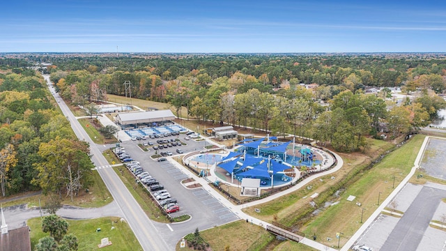 drone / aerial view featuring a wooded view