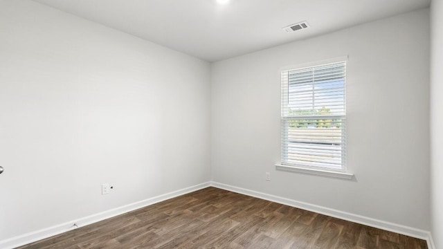 1009 Folly Rd, Summerton, SC 29148 - unfurnished room featuring dark wood-style flooring, baseboards, and visible vents