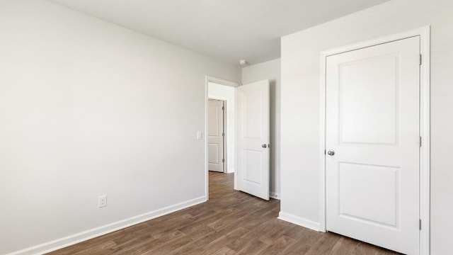 1009 Folly Rd, Summerton, SC 29148 - unfurnished bedroom featuring baseboards and wood finished floors