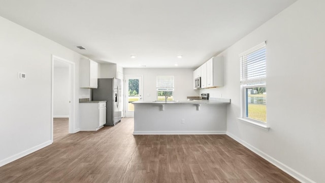 1009 Folly Rd, Summerton, SC 29148 - kitchen with a peninsula, white cabinets, visible vents, appliances with stainless steel finishes, and a sink