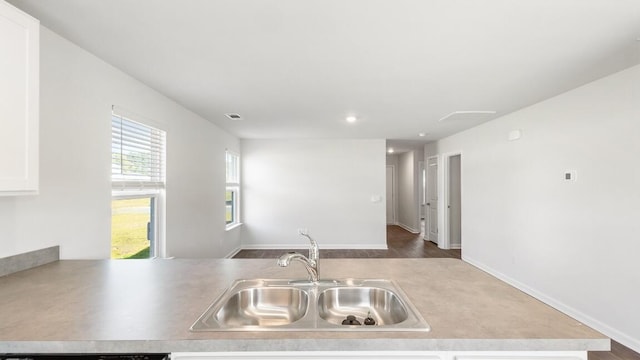 1009 Folly Rd, Summerton, SC 29148 - kitchen featuring visible vents, light countertops, a sink, and white cabinetry