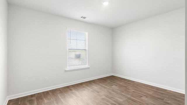 1009 Folly Rd, Summerton, SC 29148 - empty room with baseboards, dark wood-style floors, and visible vents