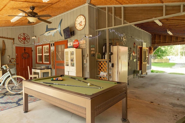 rec room featuring billiards, high vaulted ceiling, concrete floors, wooden walls, and ceiling fan