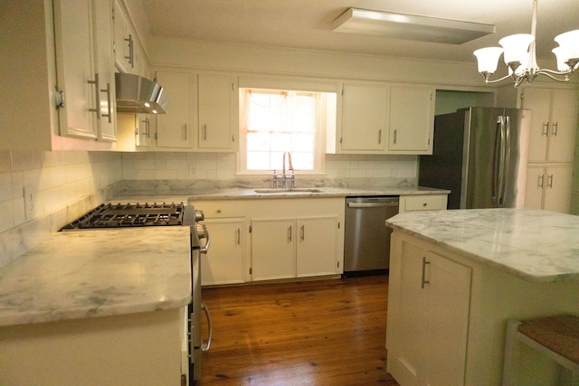 kitchen featuring sink, white cabinetry, range hood, stainless steel appliances, and light stone counters