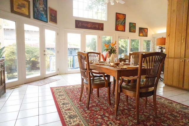 tiled dining area featuring a high ceiling