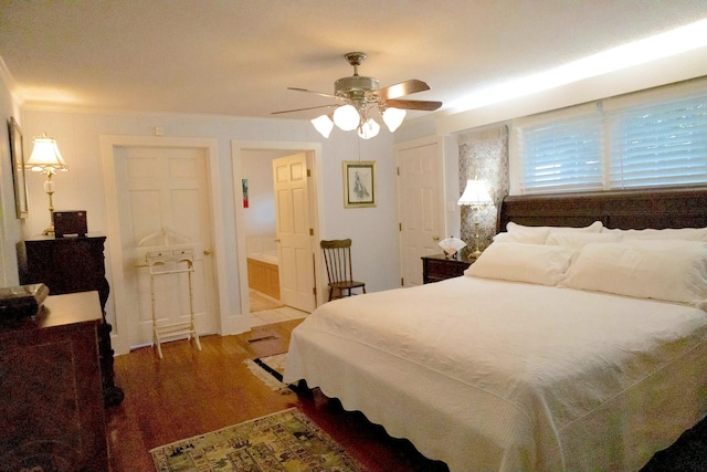 bedroom featuring connected bathroom, hardwood / wood-style flooring, and ceiling fan