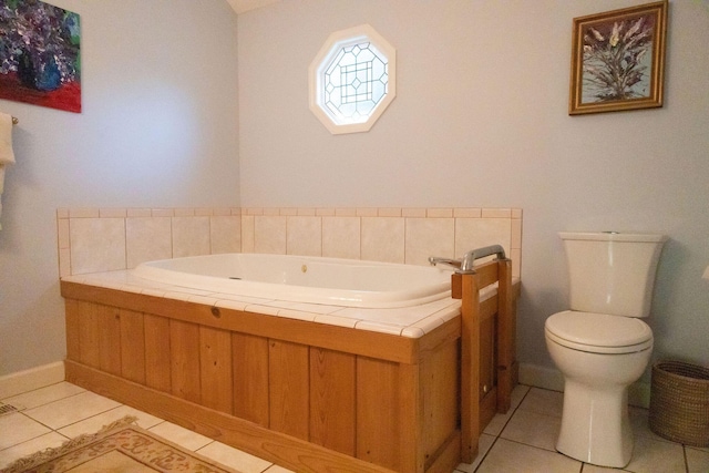 bathroom with tile patterned floors, toilet, and a washtub