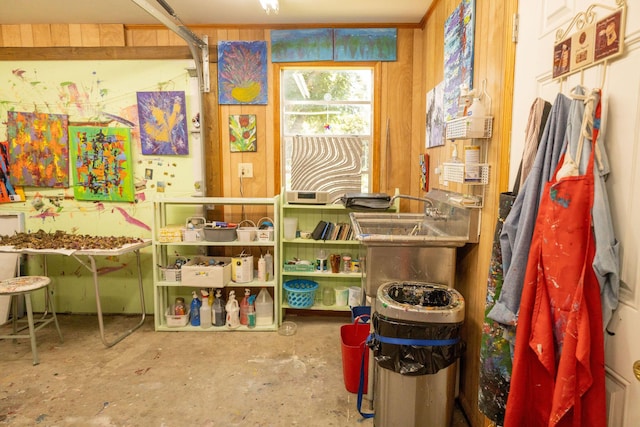 miscellaneous room featuring wooden walls and concrete flooring