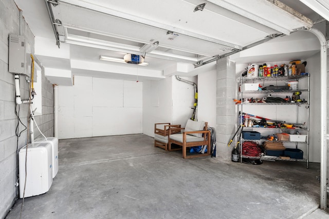 1635 Bull Creek Ln, Charleston, SC 29414 - garage featuring a garage door opener, concrete block wall, and water heater